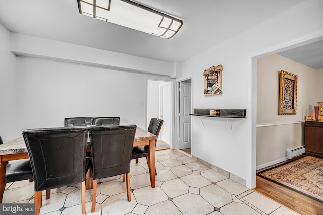 dining space featuring a baseboard heating unit