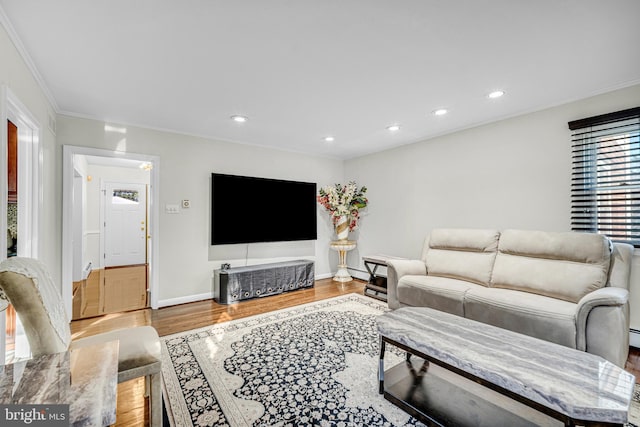 living room with hardwood / wood-style flooring and crown molding