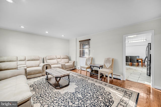 living room with light wood-type flooring and ornamental molding