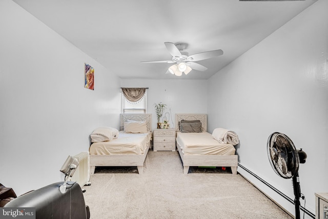 carpeted bedroom featuring ceiling fan and a baseboard radiator