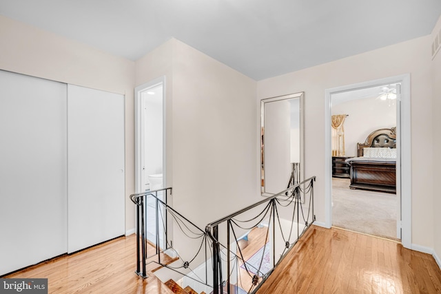 corridor with hardwood / wood-style flooring