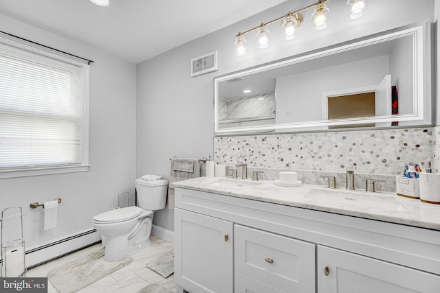 bathroom with decorative backsplash, vanity, toilet, and a baseboard heating unit