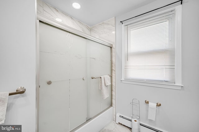 bathroom with combined bath / shower with glass door and a baseboard heating unit