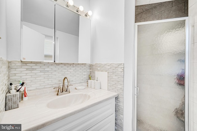 bathroom with vanity, decorative backsplash, and walk in shower