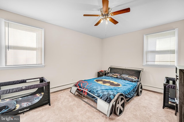 carpeted bedroom featuring ceiling fan and a baseboard radiator