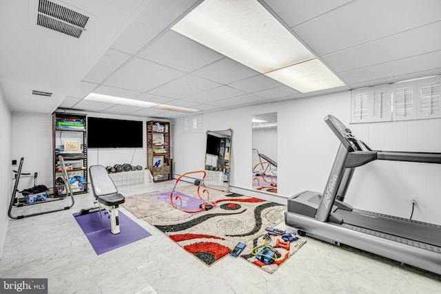 exercise room with a drop ceiling