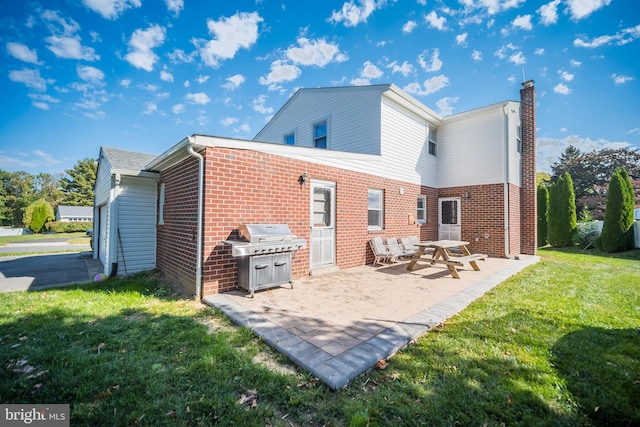 back of property featuring a lawn and a patio