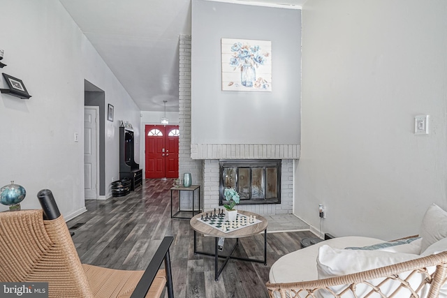 living room featuring hardwood / wood-style floors and a brick fireplace