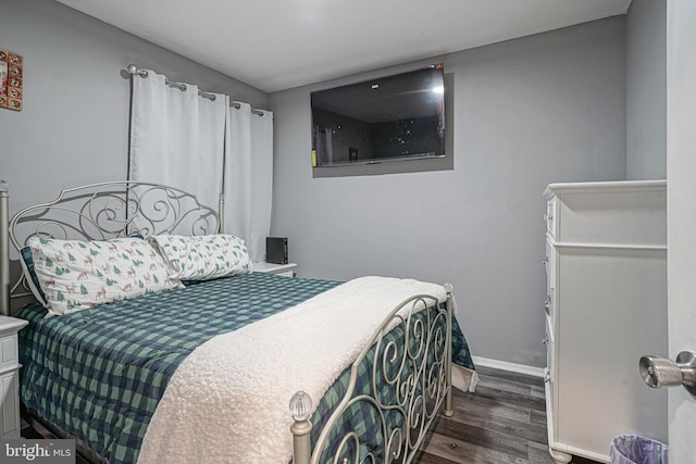 bedroom with dark hardwood / wood-style floors