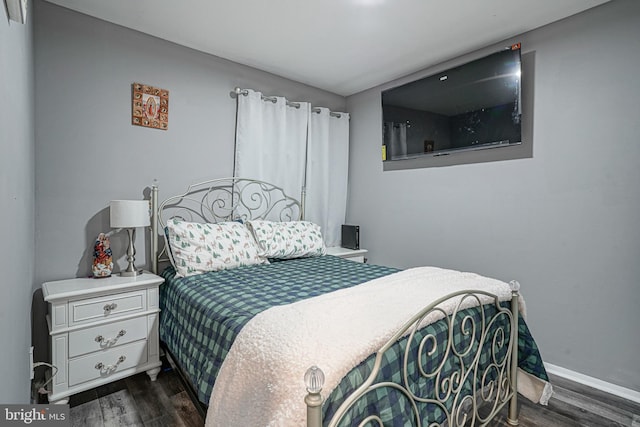 bedroom with dark wood-type flooring