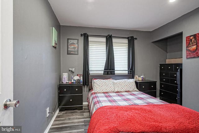 bedroom featuring dark hardwood / wood-style flooring