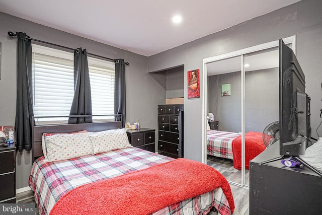 bedroom with a closet and dark wood-type flooring