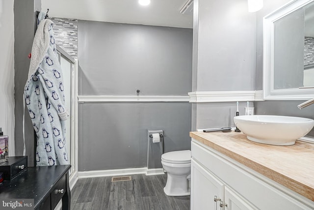 bathroom featuring hardwood / wood-style floors, vanity, and toilet