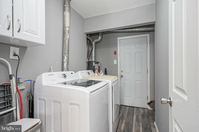 washroom featuring dark hardwood / wood-style flooring, cabinets, and independent washer and dryer