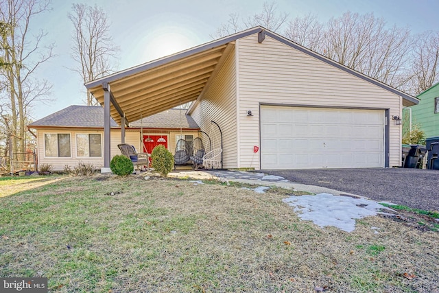 view of front of home featuring a garage and a front lawn