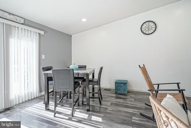 dining room featuring hardwood / wood-style flooring and a wealth of natural light