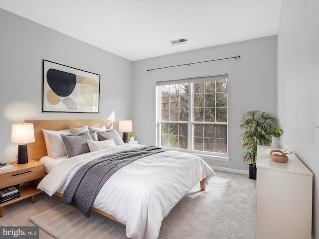 bedroom featuring light colored carpet