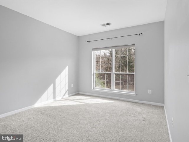 unfurnished room featuring light colored carpet