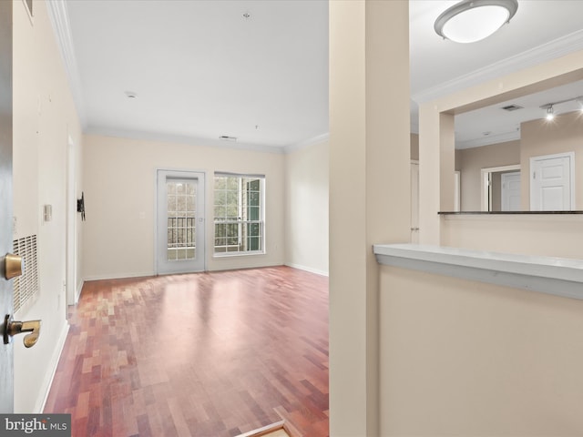 unfurnished living room featuring ornamental molding and hardwood / wood-style floors