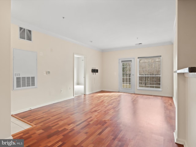 unfurnished living room featuring ornamental molding and light hardwood / wood-style floors