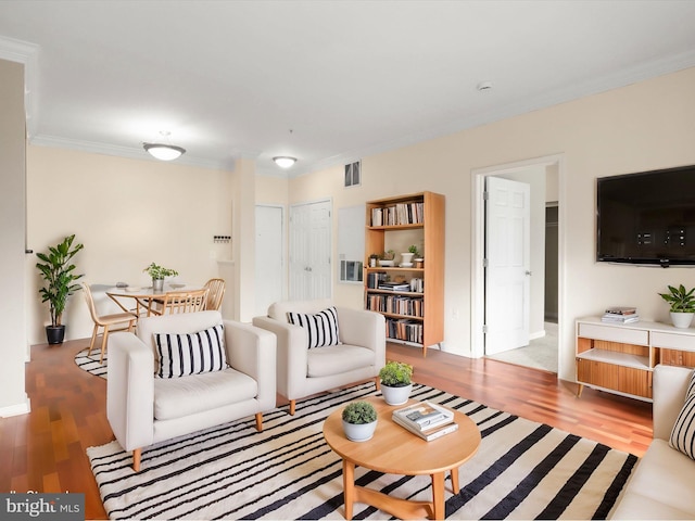 living room featuring ornamental molding and wood-type flooring