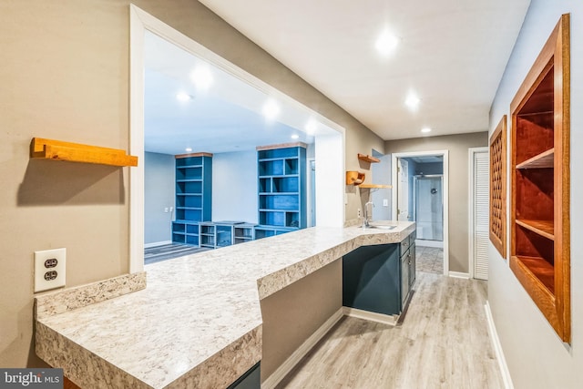 kitchen featuring light wood-type flooring and sink