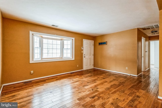 unfurnished room featuring hardwood / wood-style floors