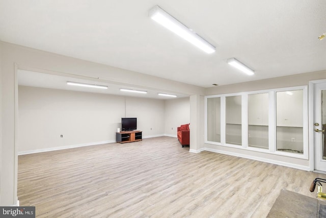 basement with light hardwood / wood-style floors