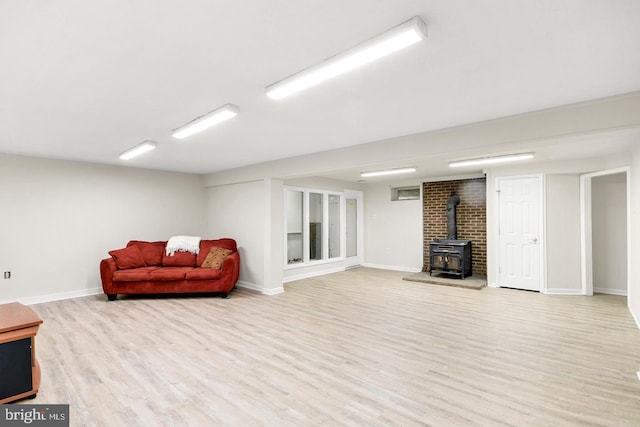 interior space with a wood stove and light wood-type flooring