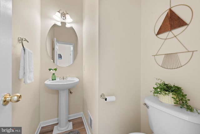 bathroom featuring sink, hardwood / wood-style floors, and toilet