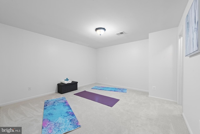 workout area featuring light colored carpet