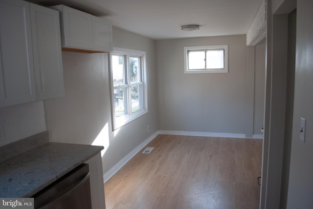 unfurnished dining area with light hardwood / wood-style floors