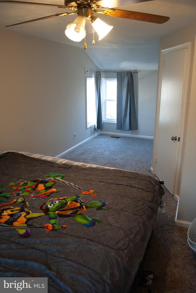 carpeted bedroom featuring ceiling fan and vaulted ceiling