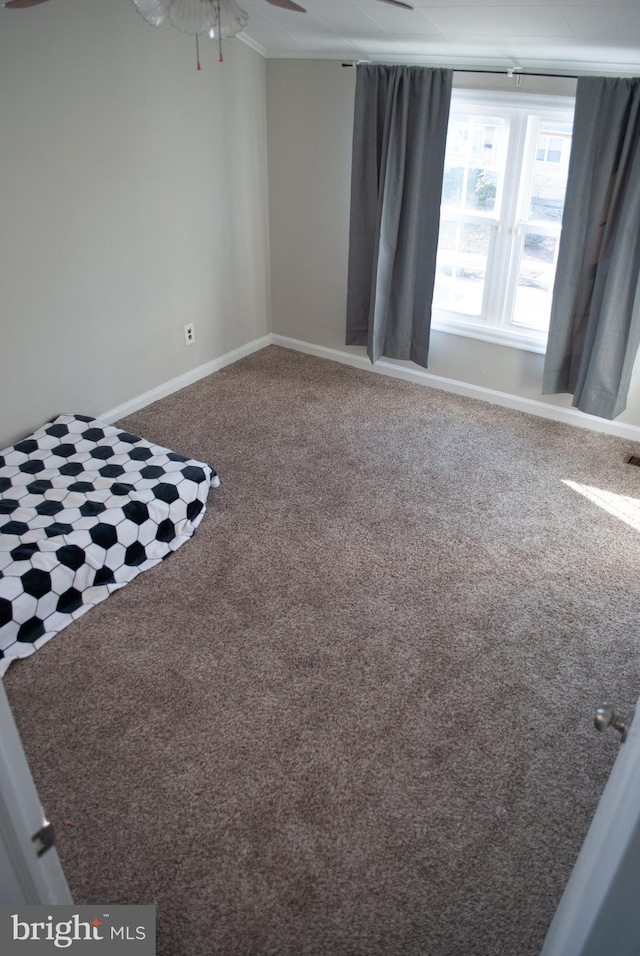 interior space featuring carpet flooring and ceiling fan