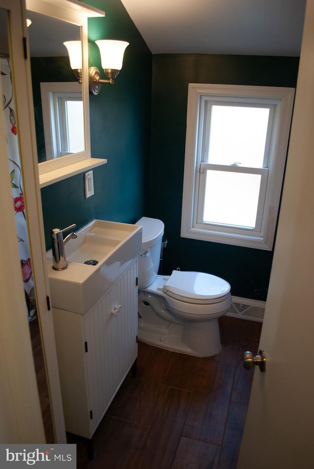 bathroom featuring hardwood / wood-style floors, vanity, and toilet