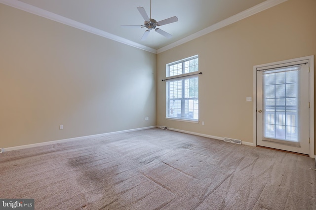 carpeted empty room with crown molding and ceiling fan