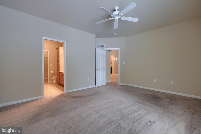 unfurnished bedroom with ceiling fan, connected bathroom, and light carpet