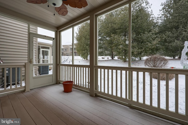 unfurnished sunroom featuring ceiling fan