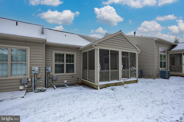 snow covered house with a sunroom