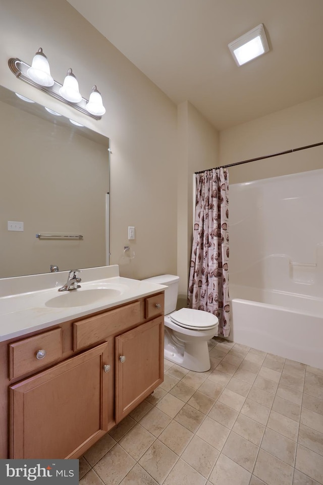 full bathroom with vanity, shower / bath combination with curtain, tile patterned floors, and toilet