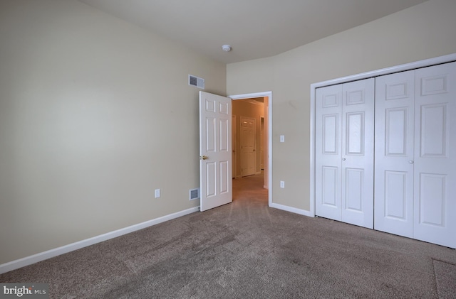 unfurnished bedroom with carpet floors and a closet