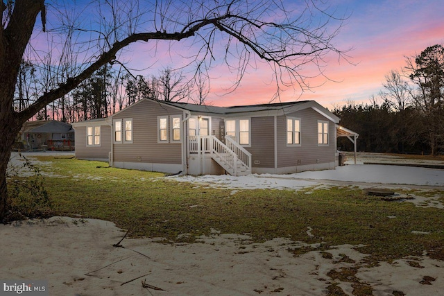 view of front of house with a lawn and a carport