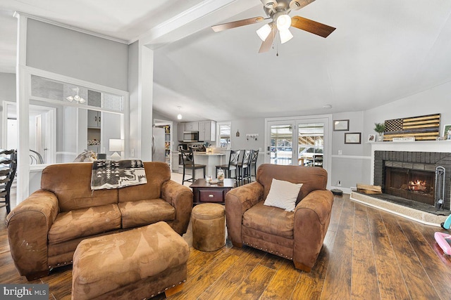 living room with ceiling fan, dark hardwood / wood-style flooring, lofted ceiling, and a fireplace