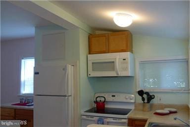 kitchen with white appliances and sink