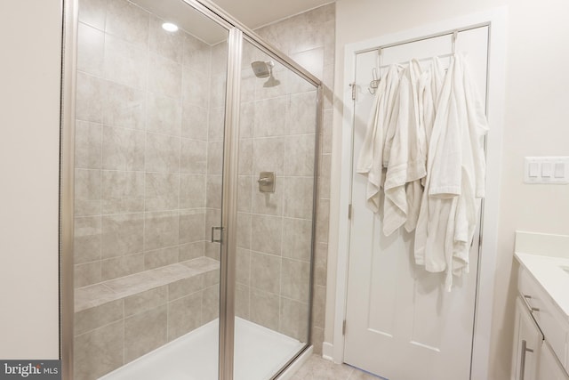 bathroom featuring vanity and an enclosed shower