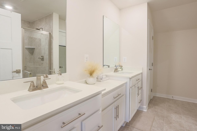 bathroom featuring tile patterned floors, a shower with shower door, and vanity