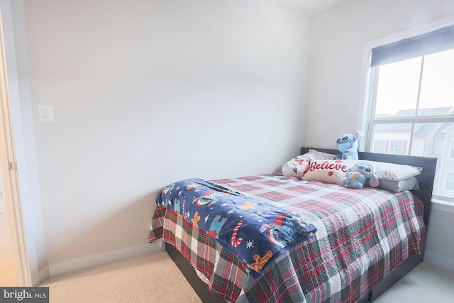 bedroom with light colored carpet