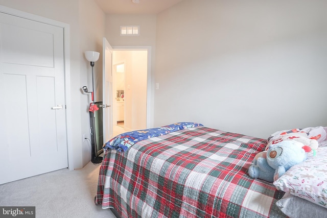 bedroom featuring light colored carpet