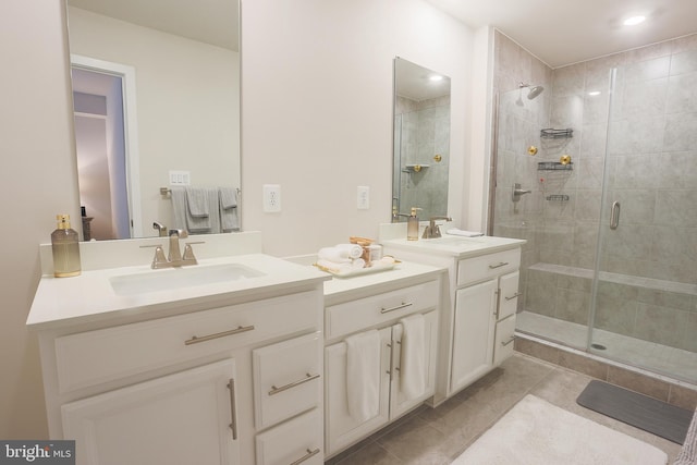 bathroom with tile patterned flooring, vanity, and a shower with shower door