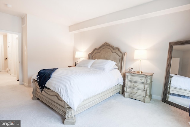 bedroom featuring light colored carpet